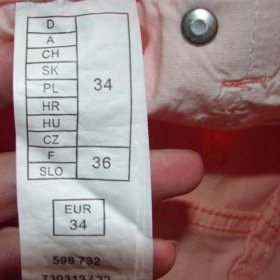 Meruňková mini sukně Orsay s aplikací na zadních kapsách - foto č. 1